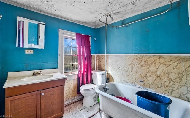 bathroom featuring toilet, tile patterned floors, a bath, and vanity