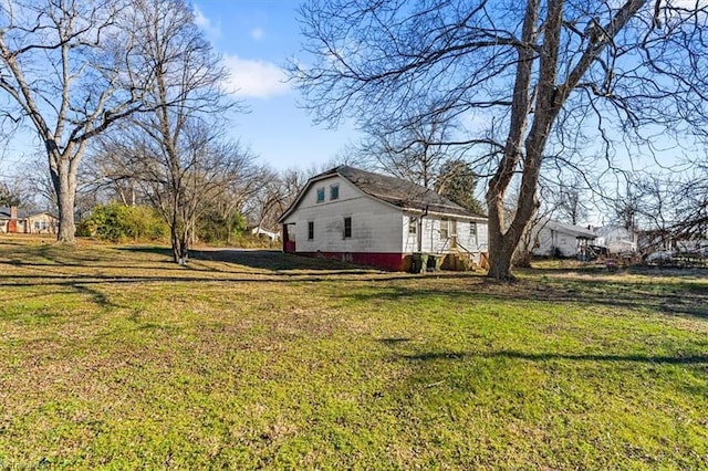 view of home's exterior with a lawn