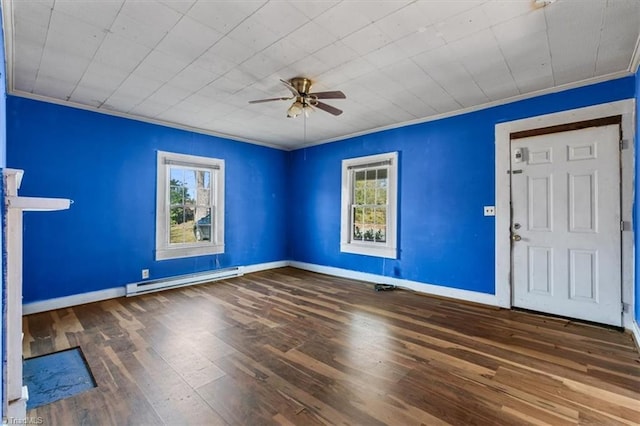 interior space featuring a healthy amount of sunlight, crown molding, baseboard heating, and wood finished floors