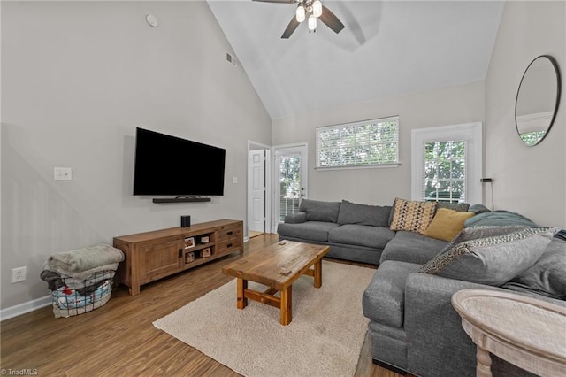 living room featuring ceiling fan, high vaulted ceiling, wood finished floors, and baseboards