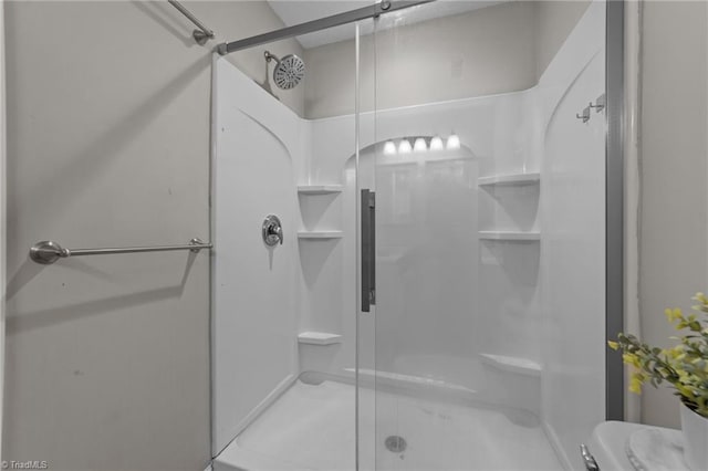 full bath with a stall shower and toilet