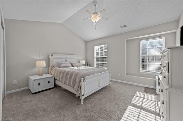bedroom with lofted ceiling, light carpet, baseboards, and ceiling fan