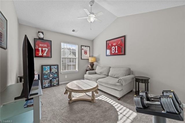 living area with ceiling fan, carpet, vaulted ceiling, baseboards, and a textured ceiling