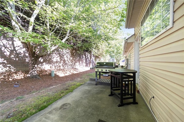 view of patio with grilling area and fence