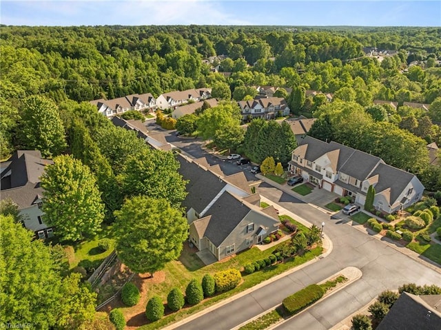 aerial view of residential area featuring a forest