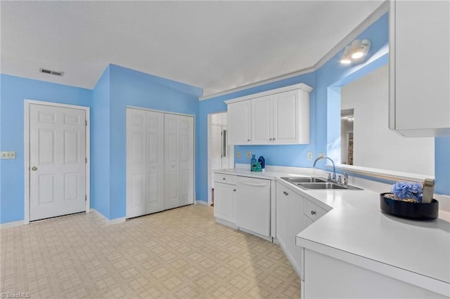 kitchen with white cabinetry, sink, and dishwasher