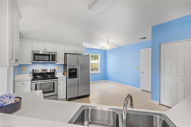 kitchen featuring vaulted ceiling, white cabinetry, sink, and appliances with stainless steel finishes