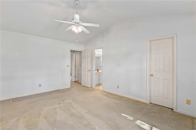 unfurnished bedroom featuring lofted ceiling, light carpet, and ceiling fan