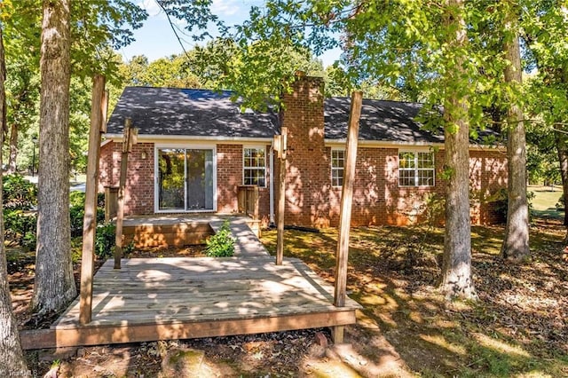 rear view of house with a wooden deck