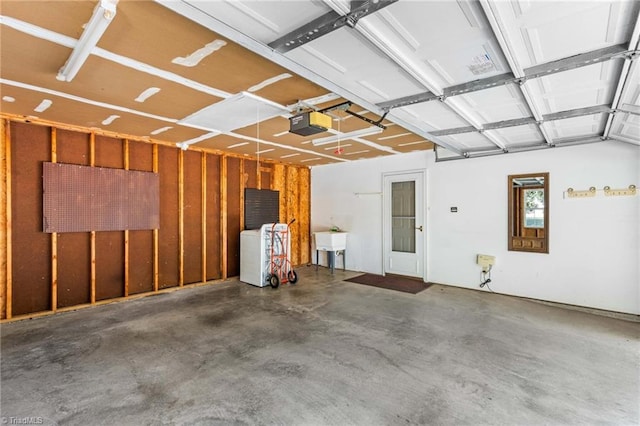 garage featuring sink and a garage door opener