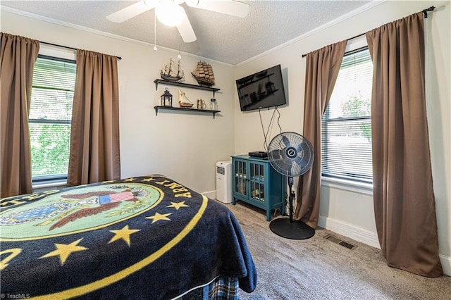 1602 Larkin St, High Point, NC 27262 - bedroom featuring carpet, ornamental molding, multiple windows, a textured ceiling, and a ceiling fan