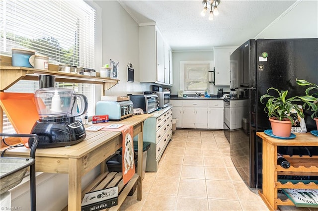 1602 Larkin St, High Point, NC 27262 - kitchen with white cabinetry, light tile patterned floors, plenty of natural light, dark countertops, and a textured ceiling