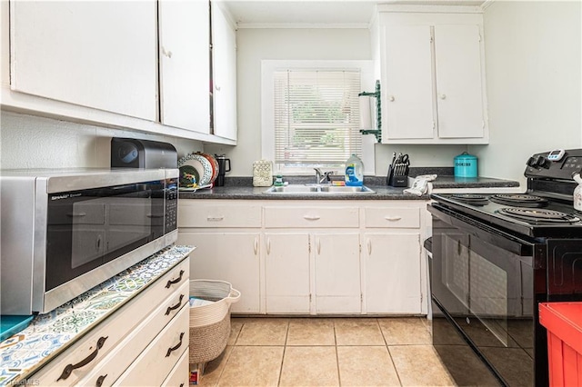 1602 Larkin St, High Point, NC 27262 - kitchen with electric range, a sink, stainless steel microwave, white cabinets, and ornamental molding