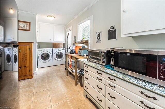 1602 Larkin St, High Point, NC 27262 - laundry area featuring washing machine and clothes dryer, ornamental molding, and light tile patterned floors