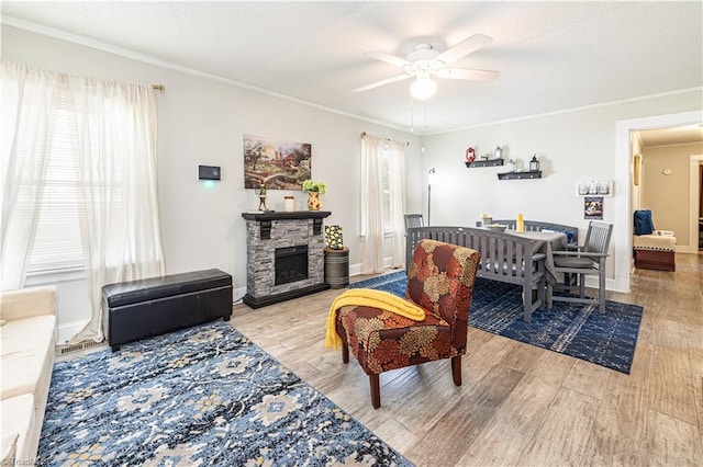 1602 Larkin St, High Point, NC 27262 - living room featuring ceiling fan, wood finished floors, a fireplace, crown molding, and baseboards