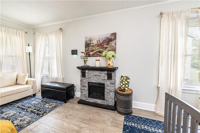 1602 Larkin St, High Point, NC 27262 - living area featuring healthy amount of natural light, crown molding, wood finished floors, a textured ceiling, and a fireplace