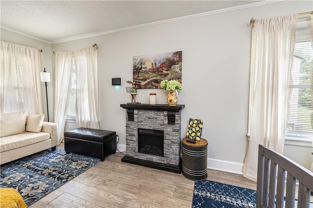 1602 Larkin St, High Point, NC 27262 - living room featuring plenty of natural light, wood finished floors, ornamental molding, a textured ceiling, and a fireplace