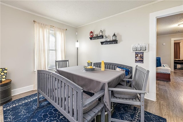 1602 Larkin St, High Point, NC 27262 - dining area with a textured ceiling, wood finished floors, crown molding, and baseboards