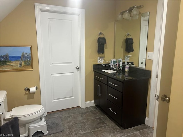 bathroom with toilet, baseboards, and vanity