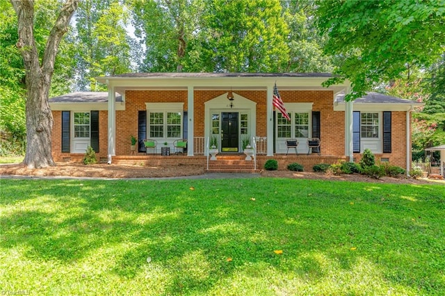 ranch-style home with covered porch and a front yard