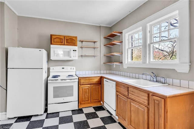 kitchen featuring white appliances, tile countertops, light floors, a sink, and crown molding