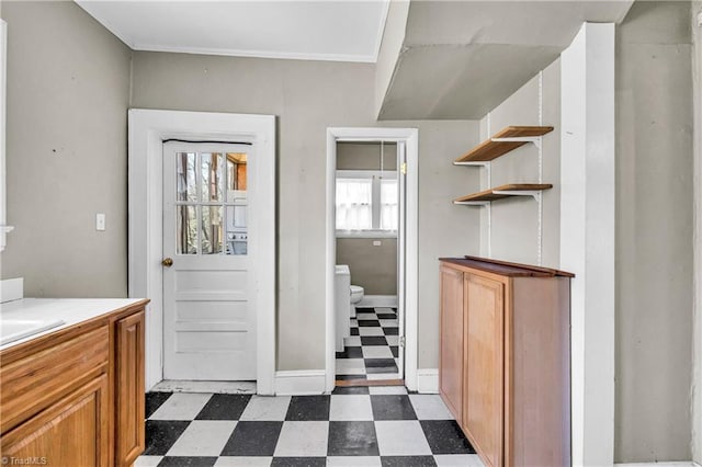 bathroom featuring vanity, tile patterned floors, toilet, and ornamental molding