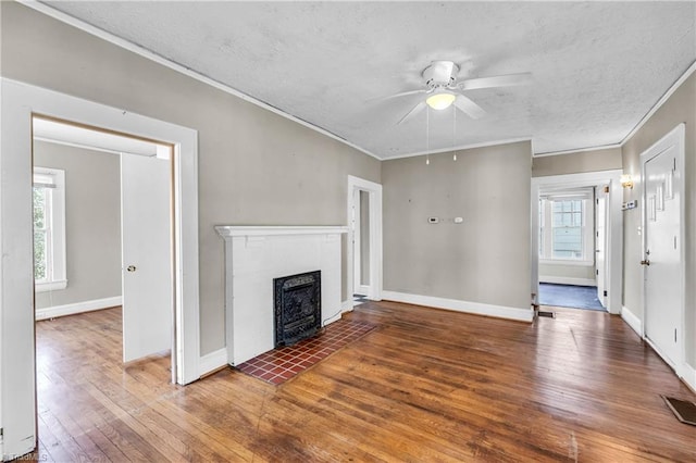 unfurnished living room with hardwood / wood-style flooring, crown molding, and ceiling fan