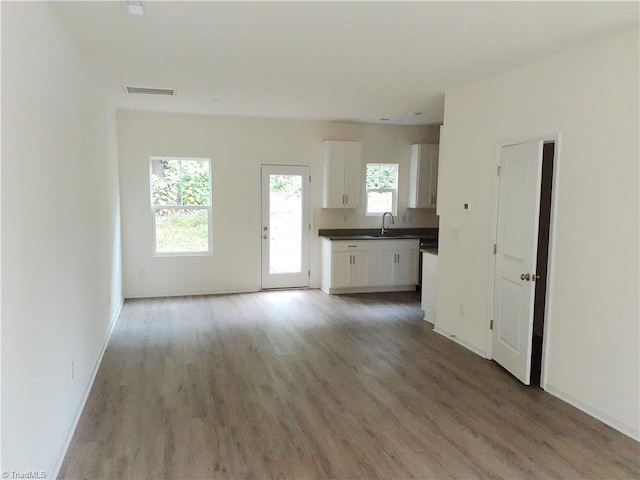 805 Granby Ave, High Point, NC 27260 - unfurnished living room with light wood finished floors and baseboards