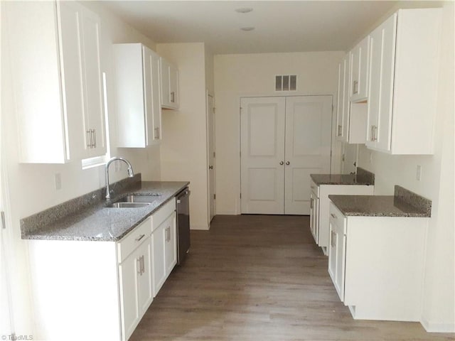 805 Granby Ave, High Point, NC 27260 - kitchen featuring stone countertops, light wood-type flooring, white cabinets, and stainless steel dishwasher