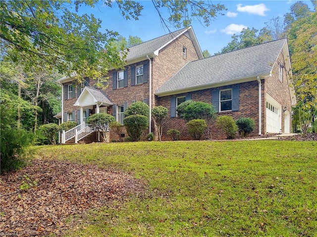 view of front of property with a garage and a front yard