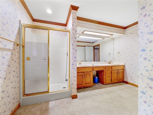 bathroom featuring a shower with shower door, vanity, tile patterned floors, and crown molding