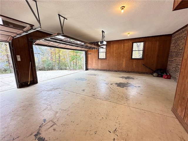 garage featuring a garage door opener and wooden walls