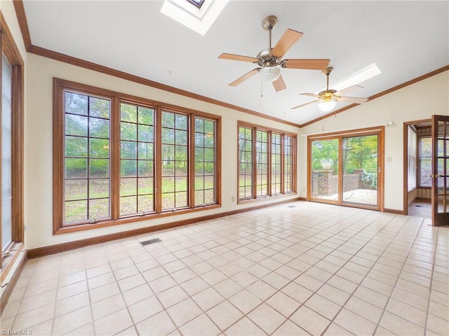 unfurnished sunroom with ceiling fan, a healthy amount of sunlight, and lofted ceiling with skylight