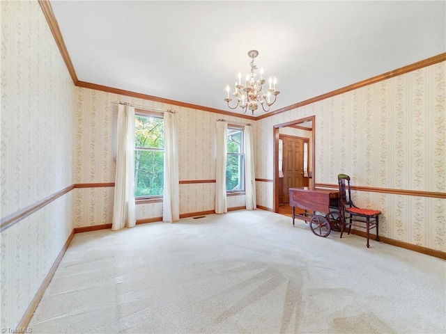 spare room featuring light colored carpet, a chandelier, and crown molding