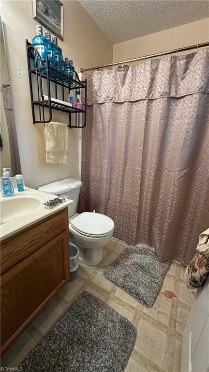 112 White St, Thomasville, NC 27360 - bathroom with vanity, a textured ceiling, and a shower with curtain
