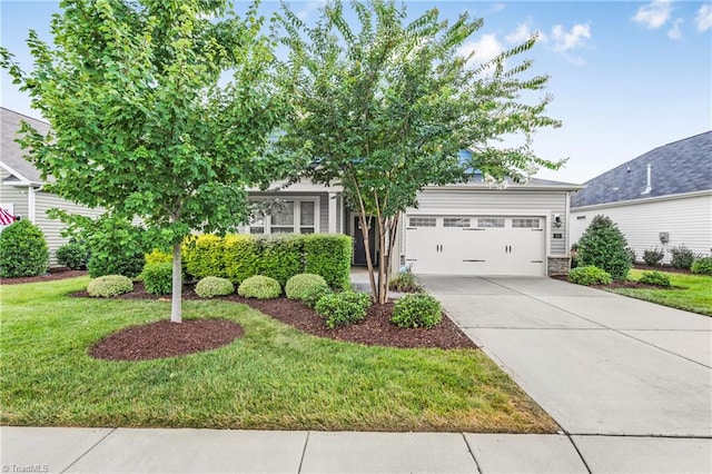 obstructed view of property featuring a garage and a front lawn