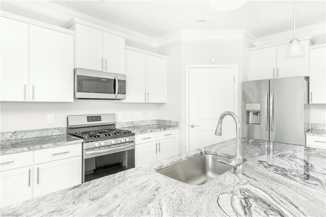 kitchen with white cabinets, hanging light fixtures, appliances with stainless steel finishes, and sink