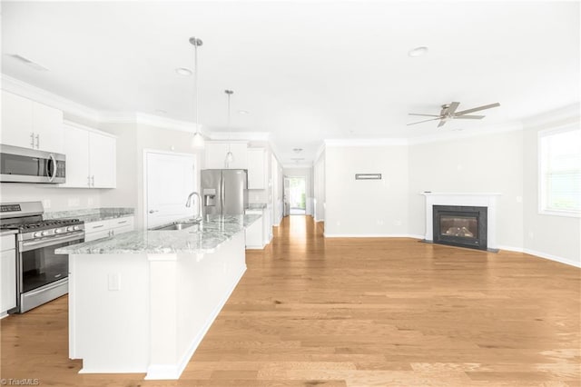 kitchen featuring white cabinets, light hardwood / wood-style floors, appliances with stainless steel finishes, and ceiling fan