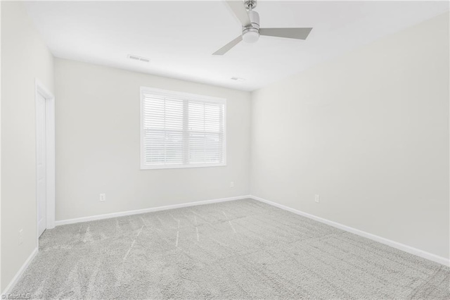 carpeted spare room with ceiling fan