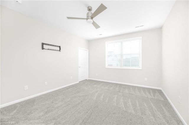 empty room with ceiling fan and carpet flooring