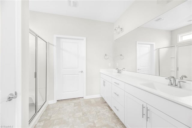 bathroom featuring double vanity, an enclosed shower, and tile patterned floors