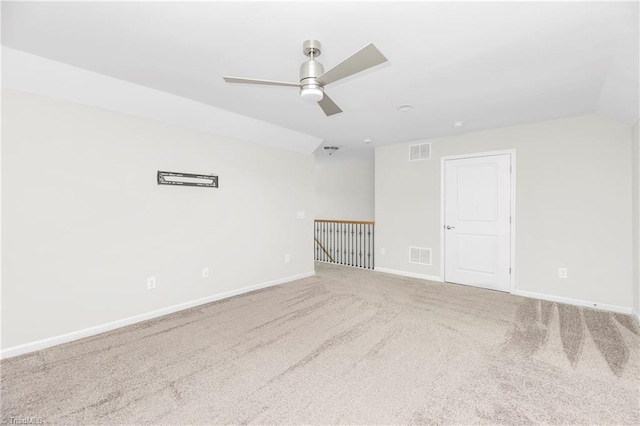 carpeted spare room with lofted ceiling and ceiling fan