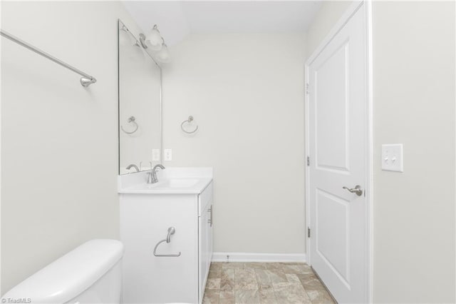 bathroom featuring tile patterned flooring, toilet, and vanity