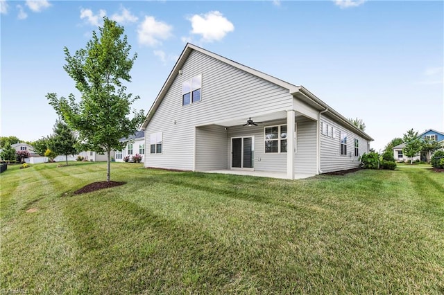 rear view of property with a yard