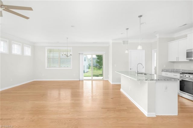 kitchen featuring white cabinets, stainless steel appliances, light hardwood / wood-style flooring, and sink