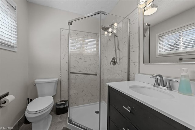 full bathroom featuring toilet, vanity, and a marble finish shower