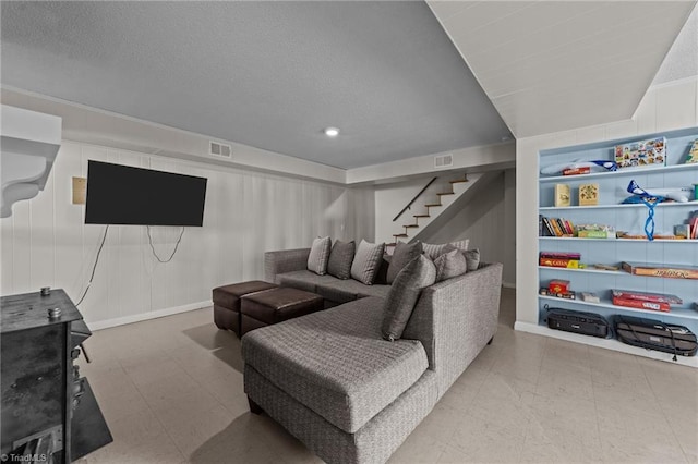 living area with visible vents, stairway, and tile patterned floors