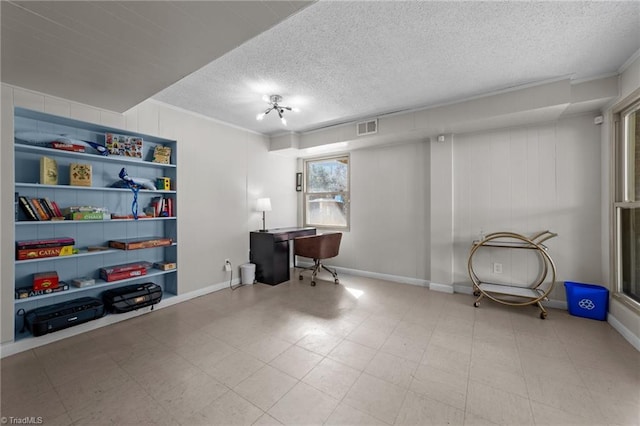 office with visible vents, ornamental molding, a textured ceiling, baseboards, and tile patterned floors