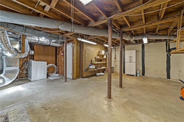 unfinished basement with washer / clothes dryer