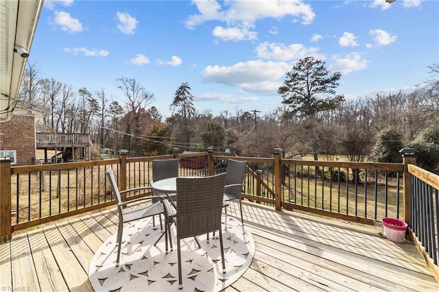 wooden deck with outdoor dining space